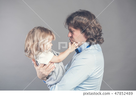 Happy smiling father holding on hands preschool daughter, looking at each other, father standing on 47852489