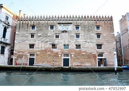 Classic Venice channel view with typical buildings, colorful windows, bridges and boats 47852997