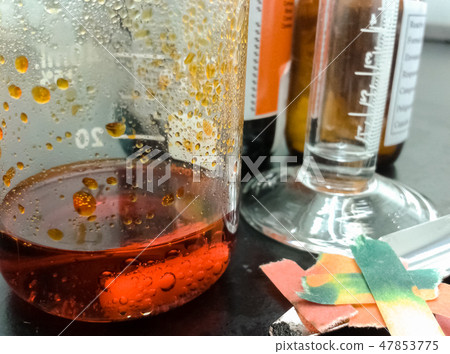 Orange chemical reaction inside a glass beaker Orange chemical reaction inside a glass beaker 47853775