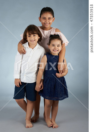 Three smiling kids standing 47853918