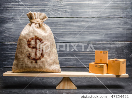 A bag of money and a bunch of boxes on the scales A bag of money and a bunch of boxes on the scales 47854431