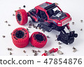 Disassembled car and scattered parts. Broken toy 47854876