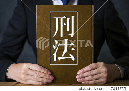 A man with a suit with a book A man with a suit with a book 47855755