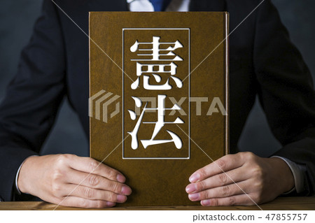 A man with a suit with a book A man with a suit with a book 47855757