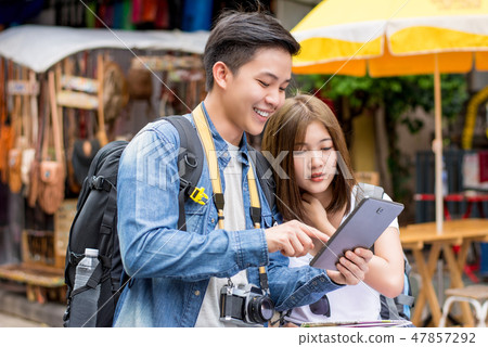 Asian tourist couple using tablet to find location 47857292