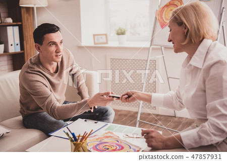 Delighted brunette male person looking at his therapist 47857931