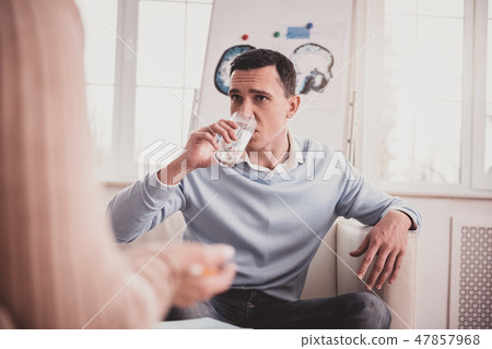 Concentrated young man listening to his therapist 47857968