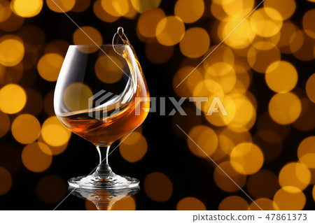 splash of brandy in snifter glass splash of brandy in snifter glass 47861373