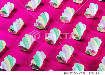 Colorful marshmallow is laid out on a red paper background  47861443