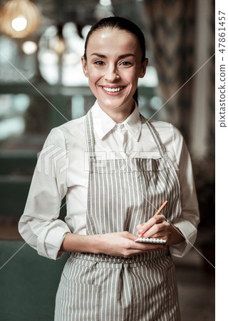 Pretty young waitress looking straight at camera 47861457