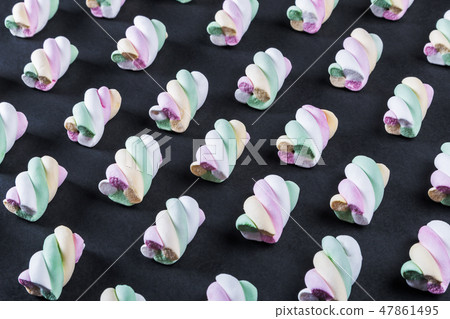 Colorful marshmallow is laid out on a black paper background Colorful marshmallow is laid out on a black paper background 47861495