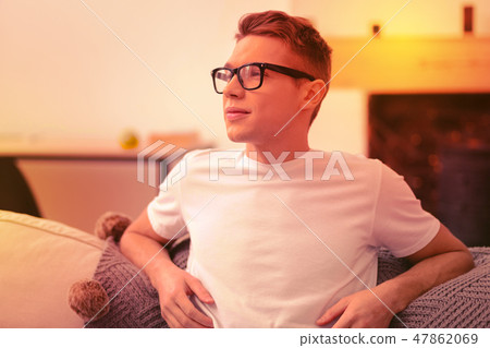 Dreamful nice guy relaxing after classes at home Dreamful nice guy relaxing after classes at home 47862069