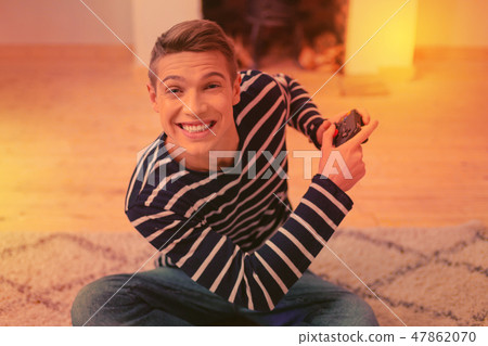 Vigorous energetic guy passing level on console 47862070