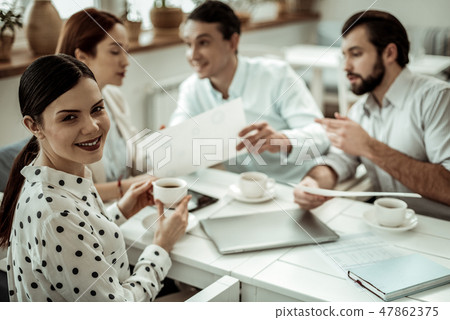 Positive delighted brunette woman looking at camera Positive delighted brunette woman looking at camera 47862375