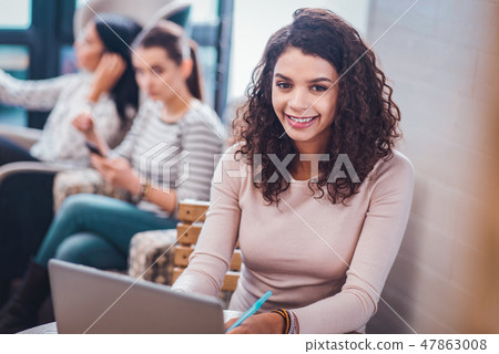 Positive joyful young woman enjoying her work Positive joyful young woman enjoying her work 47863008