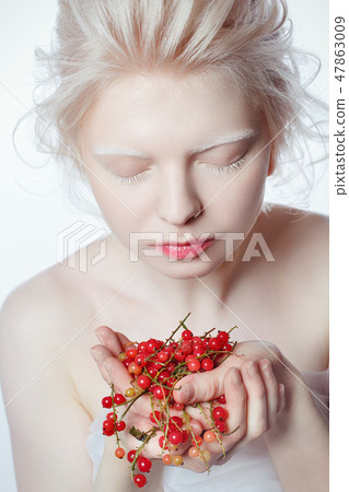 beautiful albino young woman with red berries beautiful albino young woman with red berries 47863009