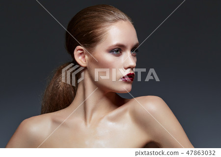 beautiful girl with long ponytail and red lips 47863032