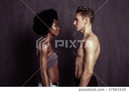 Serious young people looking at each other Serious young people looking at each other 47863426