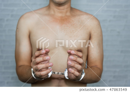 portrait of a man prisoner with handcuff portrait of a man prisoner with handcuff 47863549