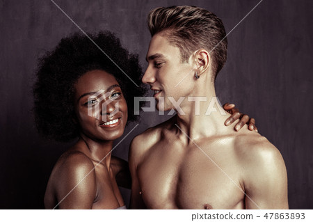 Delighted handsome fit man standing half face Delighted handsome fit man standing half face 47863893