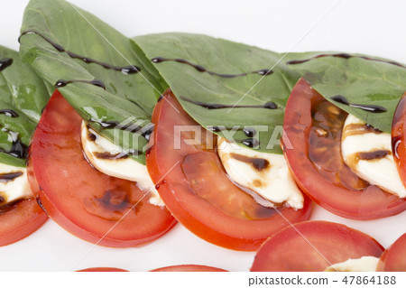 Fragment of salad with tomato and mozzarella. 47864188