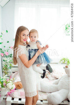 Mom hugging and kissing his little daughter 47864458