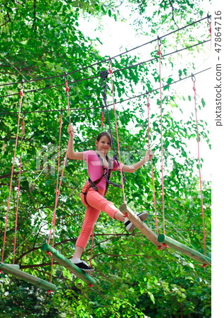 adventure climbing high wire park - hiking in the rope park girl 47864716