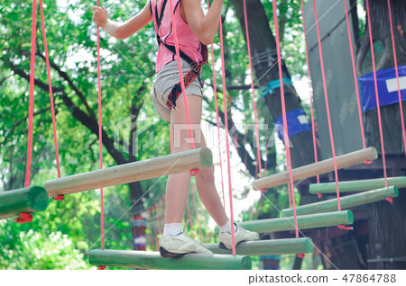 adventure climbing high wire park - hiking in the rope park girl adventure climbing high wire park - hiking in the rope park girl 47864788