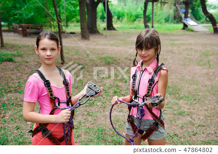 adventure climbing high wire park - hiking in rope park two girls adventure climbing high wire park - hiking in rope park two girls 47864802
