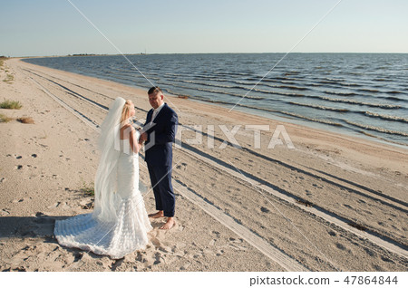 couple in love on the beach on their wedding day. couple in love on the beach on their wedding day. 47864844
