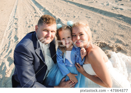 Happy family on a beach at sunrise - child mother and father Happy family on a beach at sunrise - child mother and father 47864877