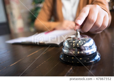 Women call hotel reception with finger push a bell Women call hotel reception with finger push a bell 47867352