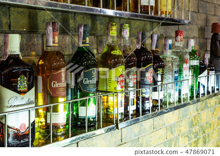 a lot of bottles with alcohol 47869071