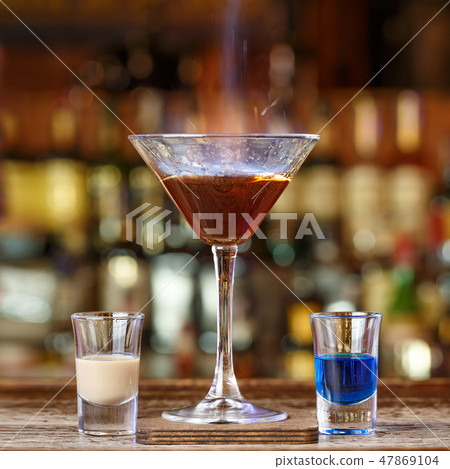 Cocktail with a burning sambuca 47869104