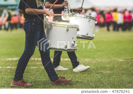 Marching band drummers perform in school parade Marching band drummers perform in school parade 47870241