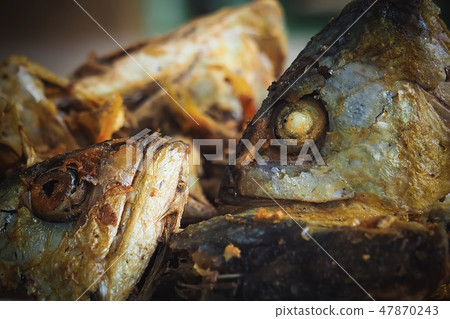 Fried fish heads for a simple meal of rural people Fried fish heads for a simple meal of rural people 47870243
