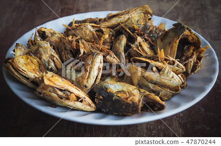 Fried fish heads for a simple meal of people Fried fish heads for a simple meal of people 47870244