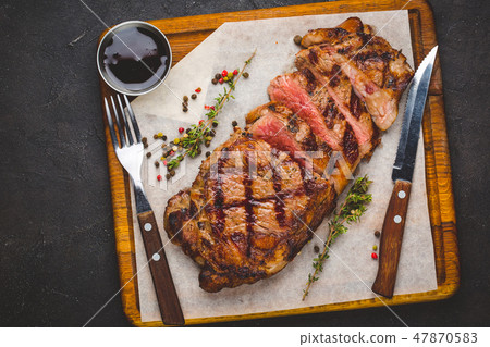 Succulent grilled large striploin steak 47870583