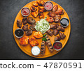 Assorted grilled meats and sauces on  wooden table 47870591