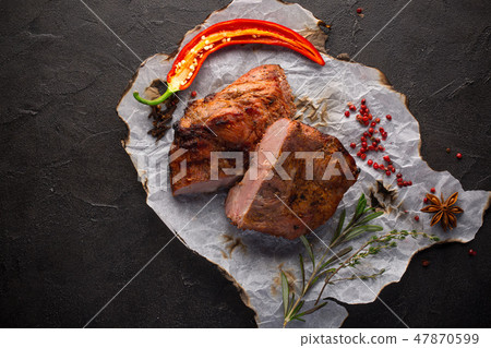 Baked meat with spices on black background Baked meat with spices on black background 47870599