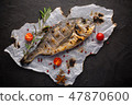 Fresh fried dorado fish with spices on black 47870600