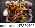 Assorted grilled meat and potatoes on black 47870602