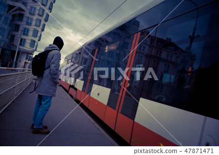 young man at the tram stop in Prague  47871471