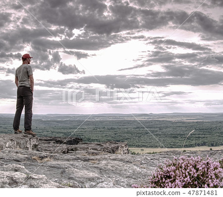 Tourist traveler standing on cliff of mountain Tourist traveler standing on cliff of mountain 47871481
