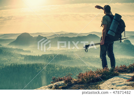 Alone tourist on hill look at nice morning land Alone tourist on hill look at nice morning land 47871482
