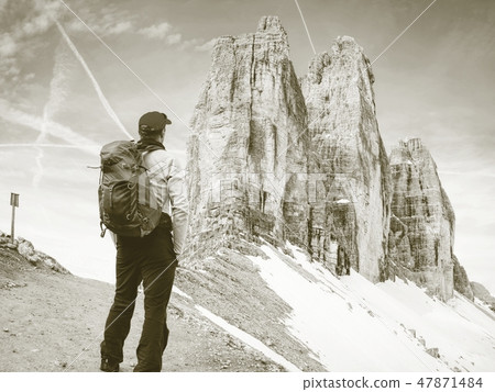 Traveler Man enjoying view to Tre Cime mountains Traveler Man enjoying view to Tre Cime mountains 47871484