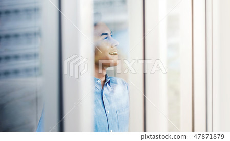 Happy Businessman Standing by the Window 47871879