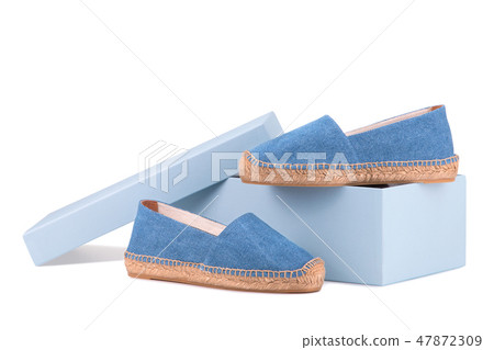 Shoe box and a pair of blue espadrilles Shoe box and a pair of blue espadrilles 47872309