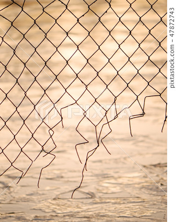 Winter romantic walk at lake,wire fence silhouette Winter romantic walk at lake,wire fence silhouette 47872743