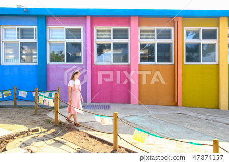 Colorful school building and female teacher concept 47874157